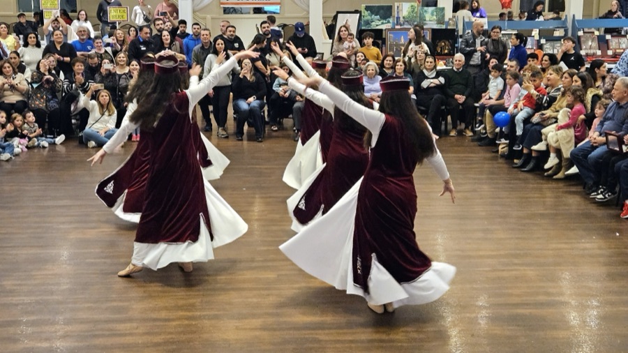 Dancers in traditional Armenian costume mid-performance