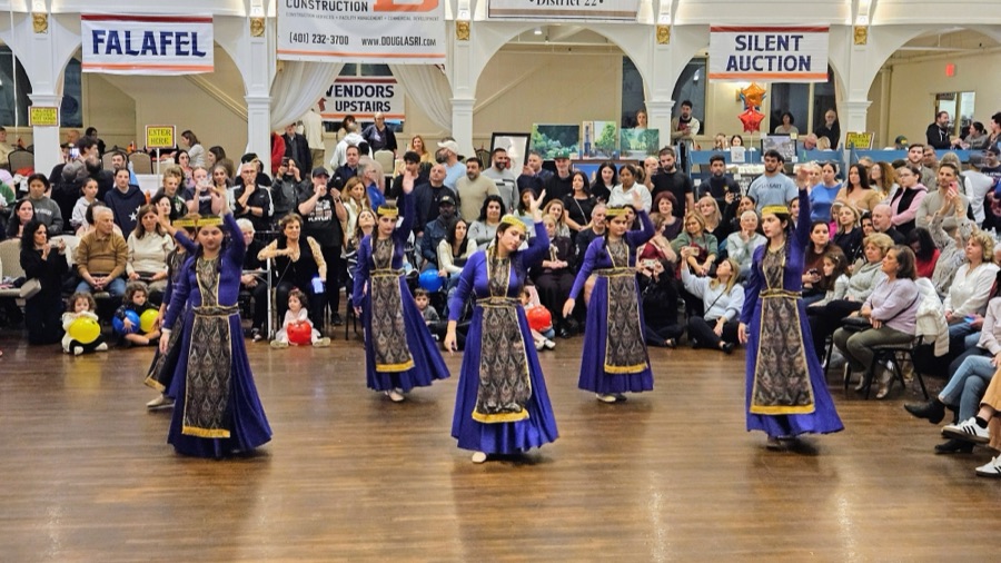 Dancers in traditional purple costumes